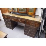 A TWENTIETH CENTURY MAHOGANY DOUBLE PEDESTAL DESK WITH NINE DRAWERS, ON PLINTH BASES, 5;6" X 1'8"