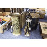 A BRASS UMBRELLA STAND, WITH REPOUSSE DECORATION, A BRASS MAGAZINE RACK WITH SAILING BOAT,