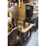 AN EDWARDIAN OAK EXTENDABLE DINING TABLE HAVING TWO ADDITIONAL LEAVES, AND A SUTHERLAND TABLE HAVING