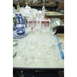 A QUANTITY OF CUT GLASS AND PLAIN GLASS DRINKING GLASSES (SOME BOXED) AND A DECANTER