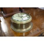 A BRASS CASED SHIPS CLOCK WITH PLATFORM ESCAPEMENT AND SECONDS DIAL