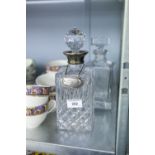 A DECANTER WITH SILVER COLLAR AND SILVER NAME PLATE, ENGRAVED 'PRESENTED TO KEN McEWAN' AND