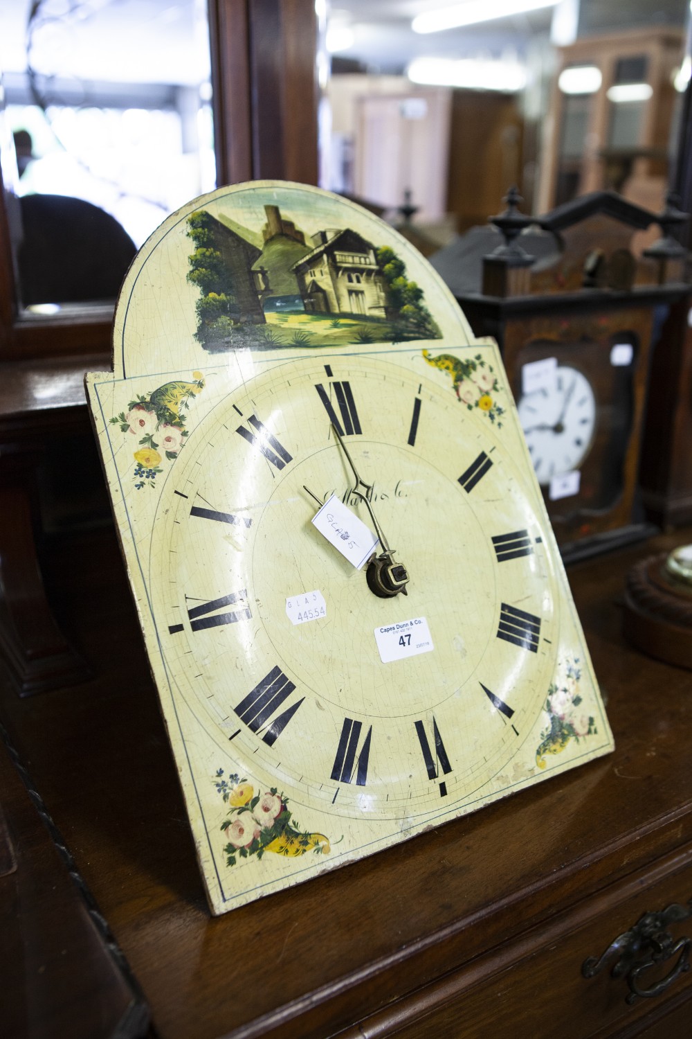 A NINETEENTH CENTURY BLACK FOREST SHIELD CLOCK WITH COLOURFUL PAINTED DIAL, TIME AND STRIKE ON A