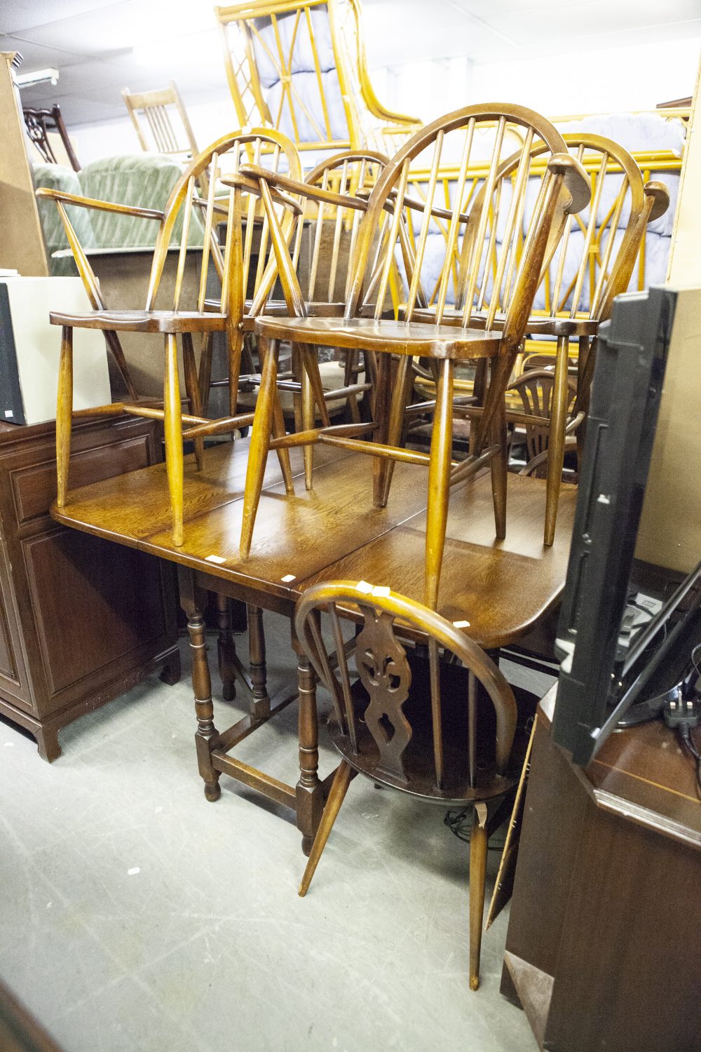 A SET OF FOUR HARDWOOD HOOP-BACK WINDSOR DINING ARMCHAIRS WITH PANEL SEATS AND A PAIR OF WHEEL