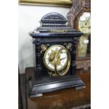 AN EIGHT DAY MANTEL CLOCK, STRIKING ON A GONG, WITH BRASS DECORATIONS ON EBONISED CASE