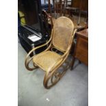 A MODERN BENTWOOD ROCKING CHAIR WITH CANE PANEL BACK AND SEAT