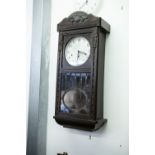 AN EIGHT DAY CLOCK, 30" TALL, SILVERED DIAL AND GLAZED LOWER SECTION IN DOOR, MADE BY KIENZLE IN