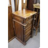 A SOLID STAINED WOOD NARROW CHEST OF FOUR DRAWERS