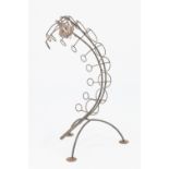 A WROUGHT IRON SNAKE SHAPED WINE RACK