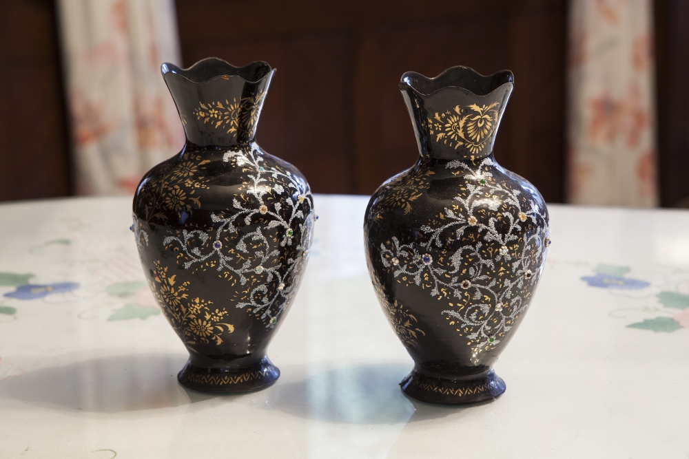 A PAIR OF ITALIAN DARK BLUE ENAMELLED METAL OVULAR VASES WITH WAVY TOPS AND HAVING ENAMELLED, GILT