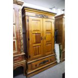 A MODERN STAINED WOOD DOUBLE WARDROBE WITH PANEL DOORS AND LARGE DRAWER TO BASE, WITH TUDOR ROSE