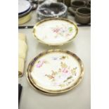 A SET OF EARLY TWENTIETH CENTURY PAINTED PLATES WITH YELLOW GROUND AND HAND PAINTED FLOWERS