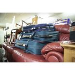 A PAIR OF CLUB HOUSE GREEN CANVAS AND LEATHER TRIMMED SUITCASES AND TWO SMALL CABIN BAGS WITH STRAPS