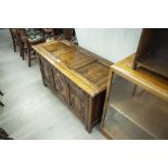 JACOBEAN STYLE TWENTIETH CENTURY CARVED OAK COFFER WITH FRAMED THREE PANEL LID AND FRONT