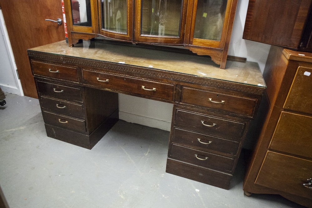 A TWENTIETH CENTURY MAHOGANY DOUBLE PEDESTAL DESK WITH NINE DRAWERS, ON PLINTH BASES, 5;6" X 1'8"