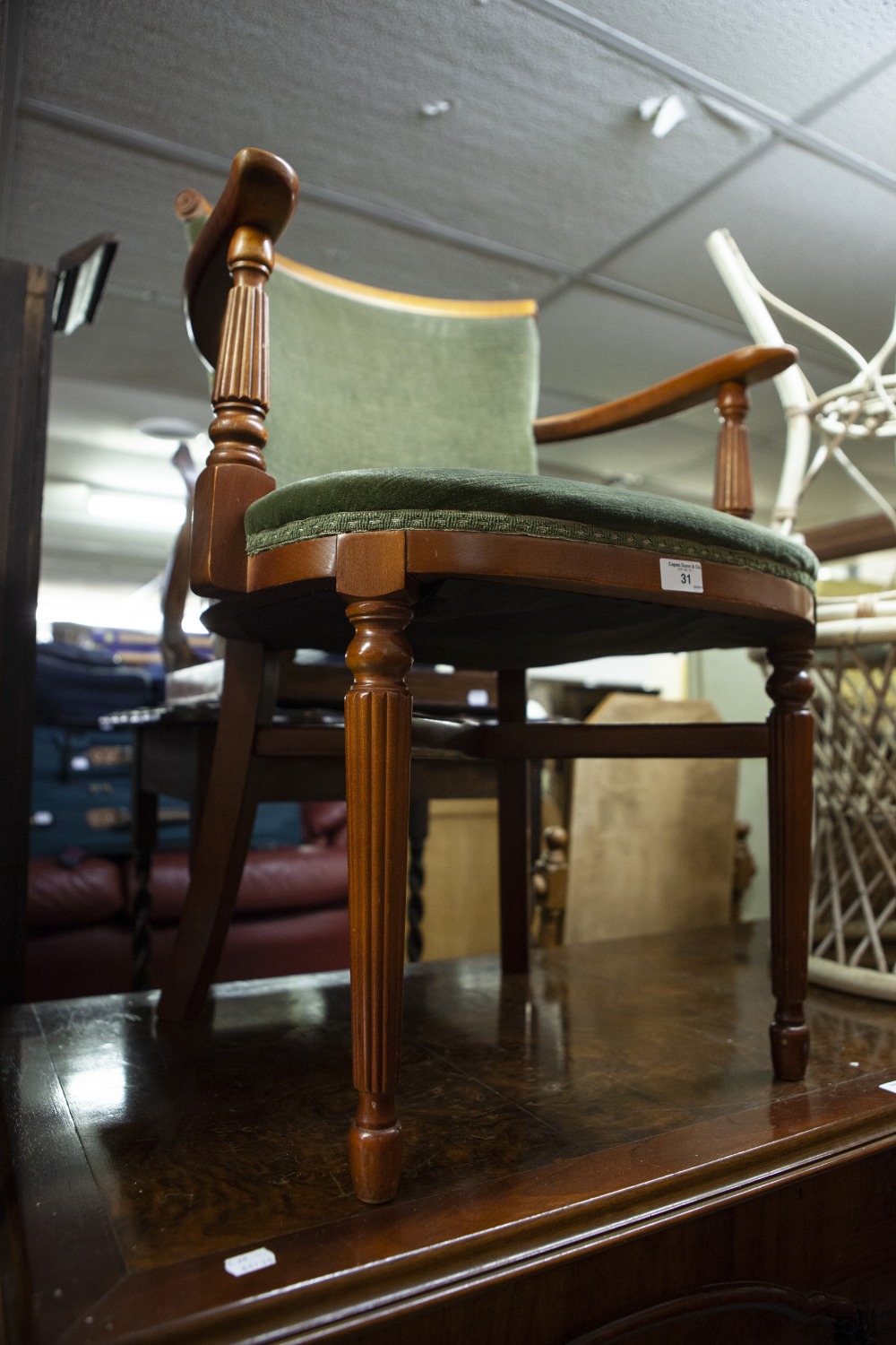 A MAHOGANY DESK CHAIR, COVERED IN GREEN VELVET