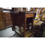 MAHOGANY DROP-LEAF DINING TABLE, AN OAK TEA TROLLEY; ANOTHER TEA TROLLEY