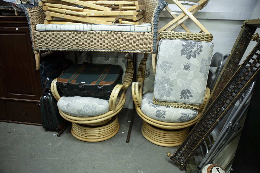 TWO LARGE BAMBOO AND CANE CONSERVATORY REVOLVING AMCHAIRS AND MATCHING FOOTSTOOLS