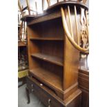 A SMALL CARVED OAK OPEN BOOKCASE