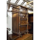 A SOLID STAINED WOOD NARROW CHEST OF FOUR DRAWERS