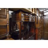 EDWARDIAN MAHOGANY SERPENTINE SIDE CABINET OF FOUR SHORT DRAWERS, ON SQUARE FLUTED SUPPORTS