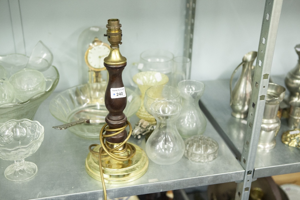 A TABLE LAMP WITH WOODEN AND BRASS STAND, AN ANNIVERSARY CLOCK WITH GLASS DOME, A GLASS BOWL AND