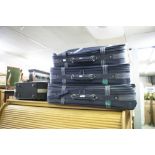 A SET OF THREE CARLTON SUITCASES AND A BLACK CABIN BAG (4)