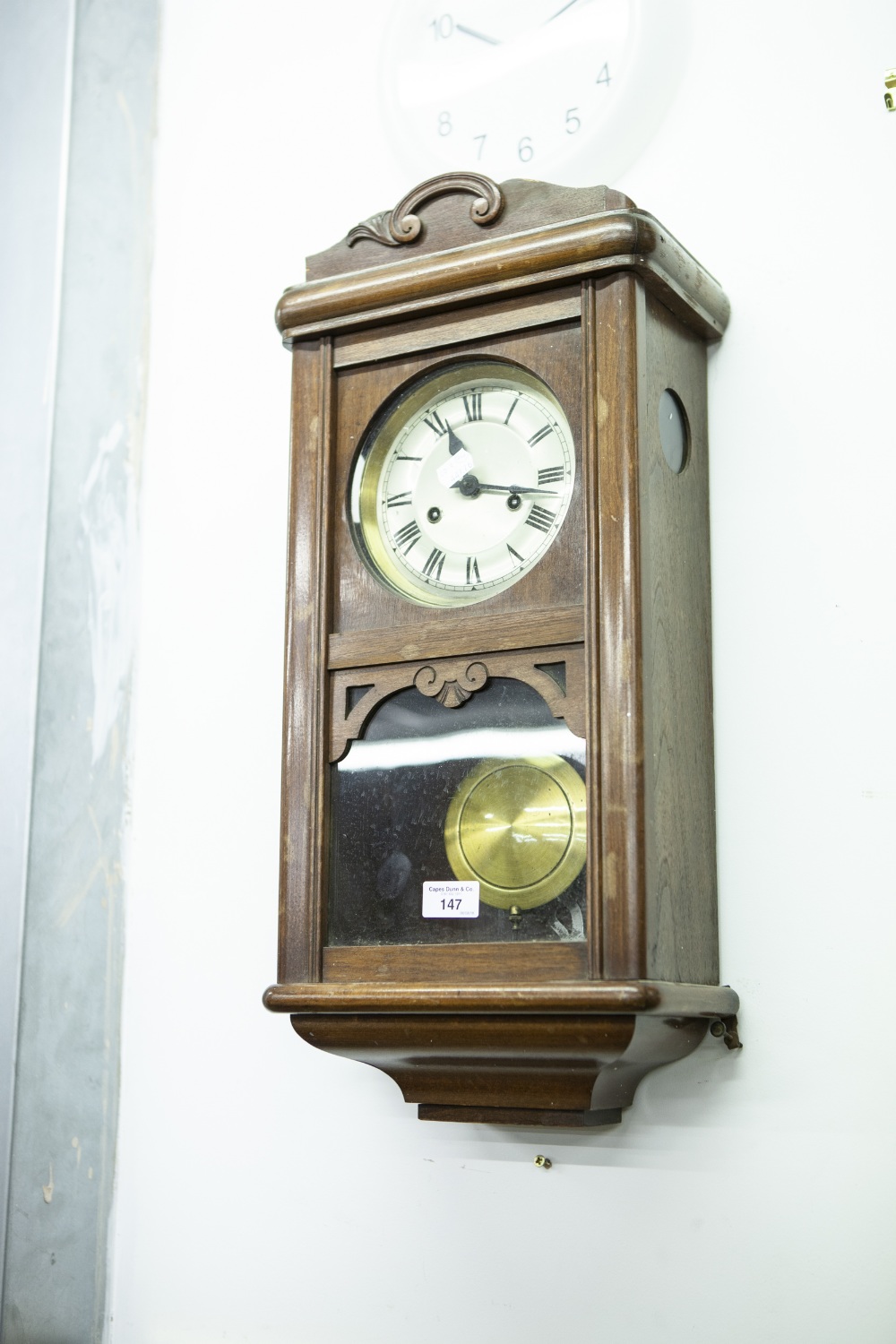 A MAHOGANY WELLINGTON TYPE WALL CLOCK