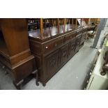 AN ORIENTAL DARK WOOD SIDEBOARD, THREE DRAWERS ABOVE THREE DOORS WITH DECORATIVE CARVED PANELS