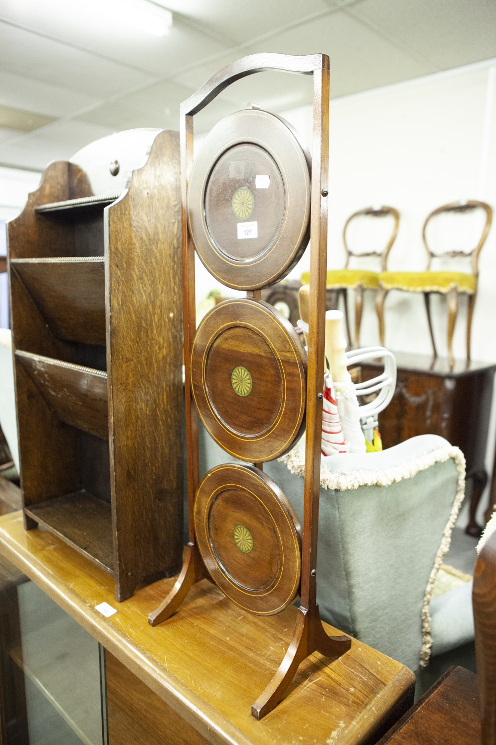 EDWARDIAN MAHOGANY AND INLAID THREE TIER FOLDING CAKE STAND, WITH PATERAE CENTRAL INLAY