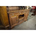 ARTS AND CRAFTS OAK SIDEBOARD HAVING TWO DRAWERS AND THREE CUPBOARD DOORS