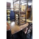 AN EDWARDIAN OAK GATELEG TABLE AND FIVE CHAIRS (4 + 1)