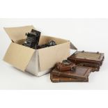 EARLY TWENTIETH CENTURY BRASS MOUNTED MAHOGANY HALF PLATE CAMERA, with two spare plate holders and