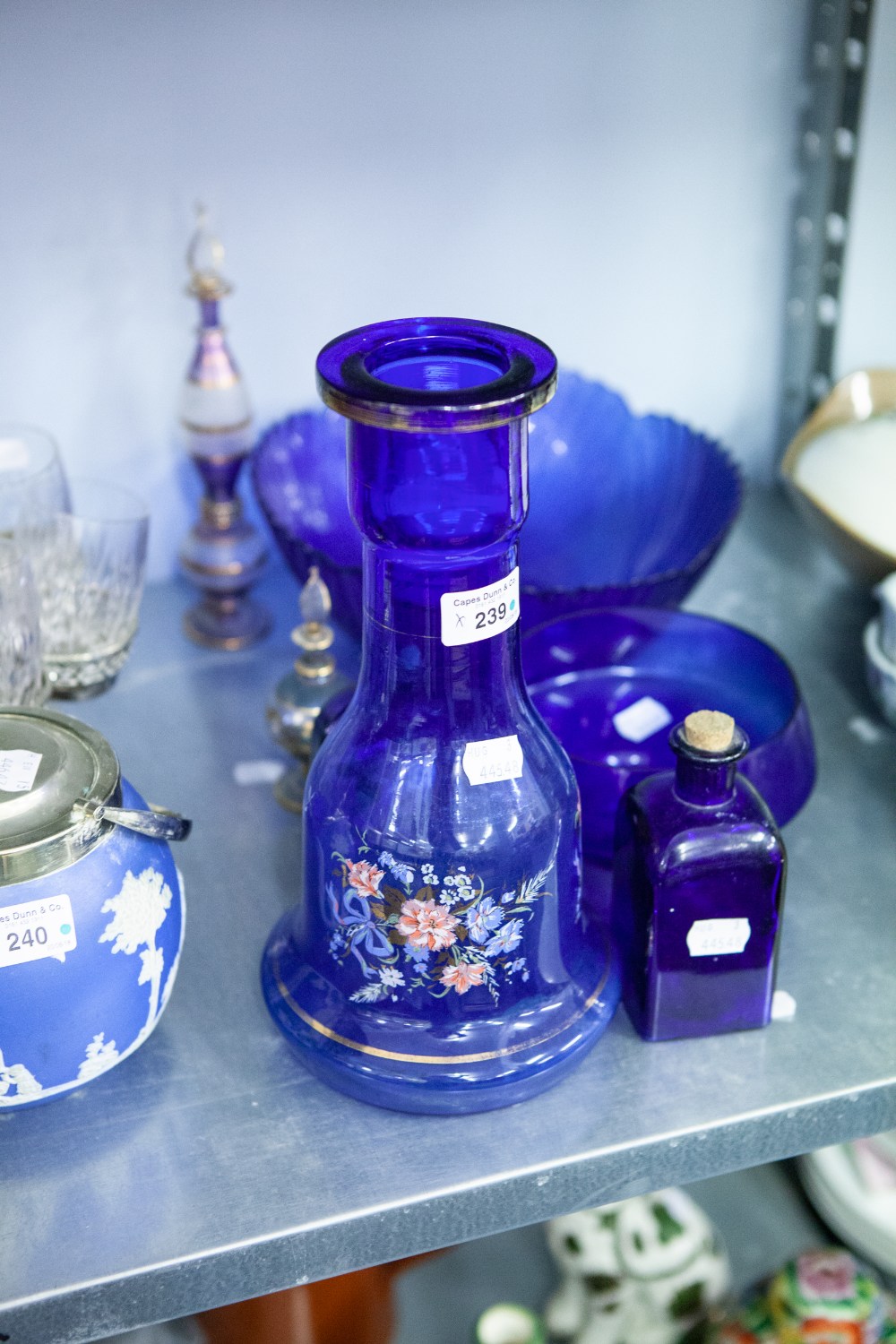 A COLLECTION OF BLUE GLASS TO INCLUDE; A BOTTLE WITH PAINTED DECORATION, BOWLS AND BOTTLES