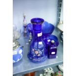 A COLLECTION OF BLUE GLASS TO INCLUDE; A BOTTLE WITH PAINTED DECORATION, BOWLS AND BOTTLES