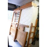 A MODERN PINE BUNK BED WITH BALL FINIAL'S, SINGLE MATTRESSES WITH LADDER AND TWO DRAWER STORAGE