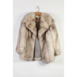 A GREY FOX FUR LADIES COAT, fold over collar, front seam pockets, two hook eye fastening, grey