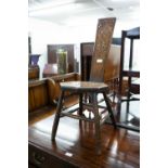 AN EARLY TWENTIETH CENTURY OAK SEWING CHAIR WITH CARVED BACK AND SEAT