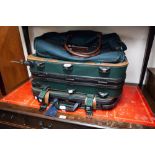 A SET OF THREE ANTLER GREEN CANVAS AND LEATHER SUITCASES AND A LARGE HOLDALL