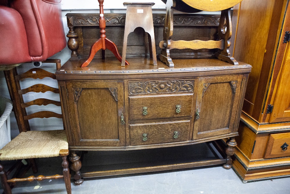 A CARVED OAK SIDEBOARD WITH CANOPY BACK