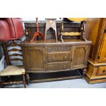 A CARVED OAK SIDEBOARD WITH CANOPY BACK