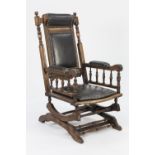 EARLY TWENTIETH CENTURY STAINED AND CARVED BEECH AMERICAN ROCKING CHAIR, of typical form with