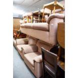 A PARKER KNOLL THREE PIECE SUITE COMPRISING A THREE SEATER SETTEE AND TWO ARMCHAIRS, IN PINK