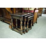 A NEST OF THREE DARK OAK OBLONG COFFEE TABLES