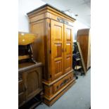 A MODERN STAINED WOOD DOUBLE WARDROBE WITH PANEL DOORS AND LARGE DRAWER TO BASE, WITH TUDOR ROSE