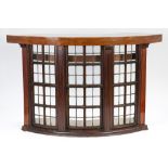 EARLY TWENTIETH CENTURY OAK FRAMED AND BOW FRONTED NIGHT WATCHMAN'S WINDOW, NOW CONVERTED INTO A