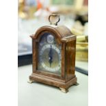 GEORGIAN STYLE ELLIOT SMALL MANTLE CLOCK, in arch top walnut case with carrying handle and wind-up