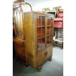 A MID TWENTIETH CENTURY OAK DISPLAY CABINET, TWO GLAZED DOORS OVER A TWO DOOR CUPBOARD, CANTED