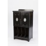 AN EDWARDIAN AESTHETIC MOVEMENT EBONISED MUSIC CABINET WITH INCISED GILT DECORATION, TWO DOORS