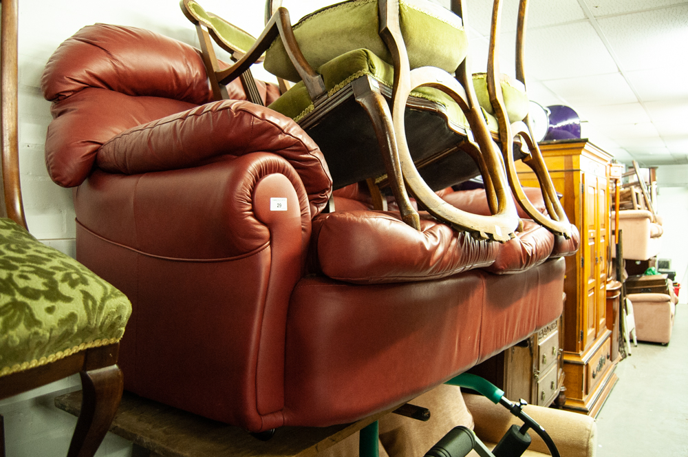 A RED HIDE THREE SEATER SETTEE